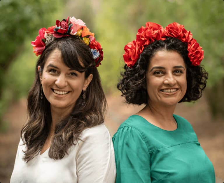 Founders of MiAltar wearing traditional flower crowns, representing cultural heritage and tradition